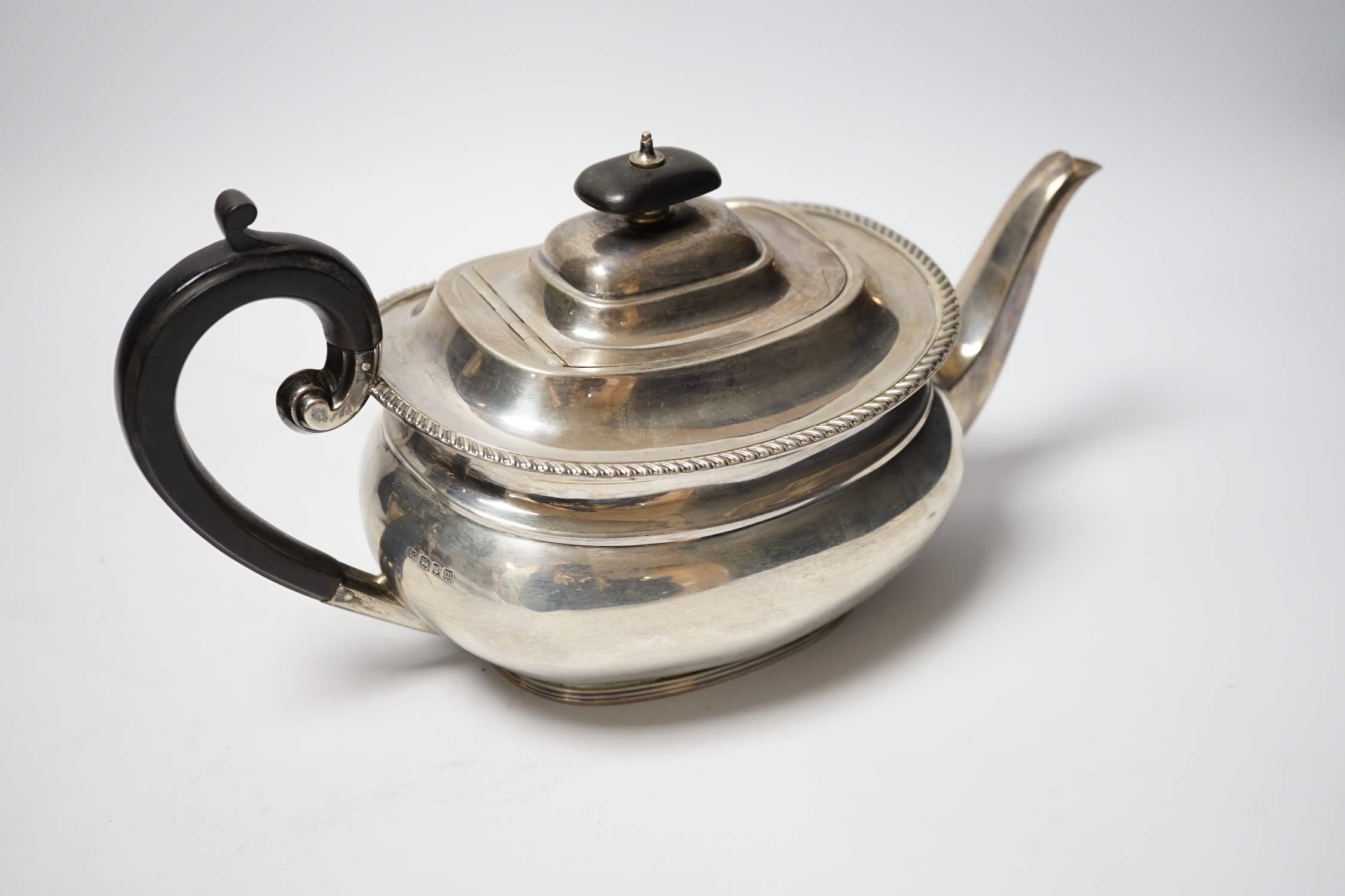 A George V silver teapot by Sebastian Garrard, London, 1927, gross weight 20.9oz.